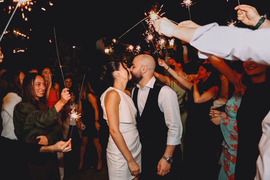 Wedding reception sparklers exit with joyful couple